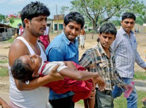 Malda: People carry a school girl toa hospital as she fainted after an earthquake in Malda district in West Bengal on Saturday. PTI Photo  (PTI4_25_2015_000077B)